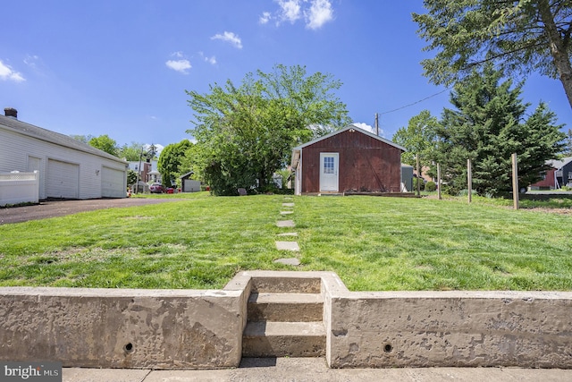 view of grassy yard with a garage