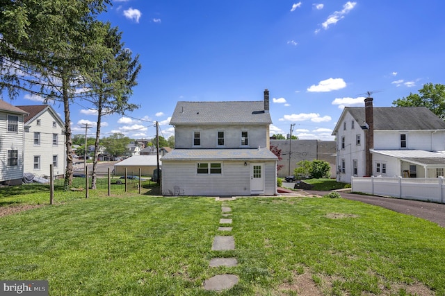 back of property featuring a residential view and a chimney