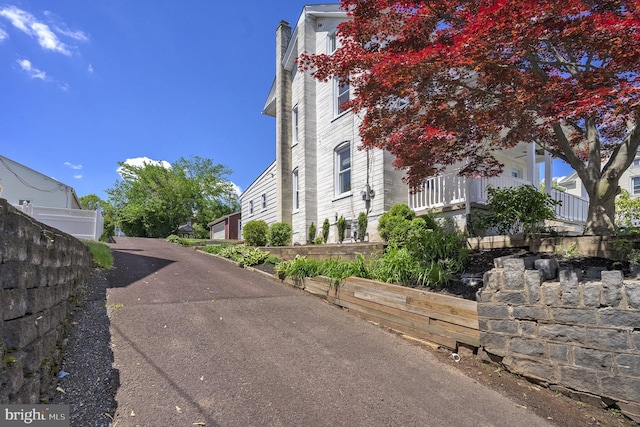 view of side of home featuring fence