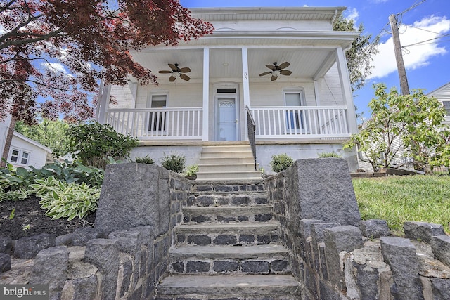 entrance to property featuring ceiling fan and covered porch