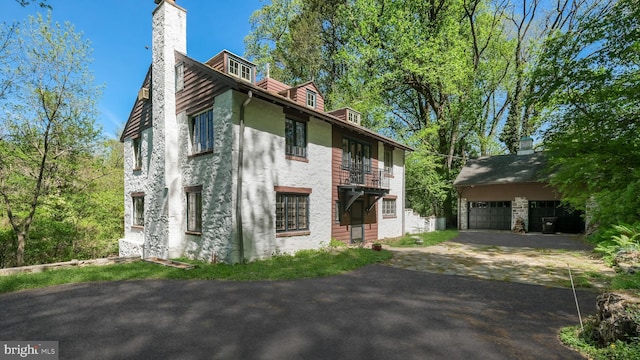 203 E Ferry Rd, Yardley, PA 19067 - view of home's exterior with a chimney, an outbuilding, and a detached garage