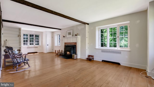 203 E Ferry Rd, Yardley, PA 19067 - living area featuring baseboards, a brick fireplace, beam ceiling, and light wood-type flooring