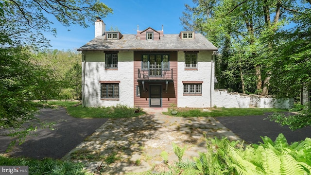 203 E Ferry Rd, Yardley, PA 19067 - view of front of house featuring a high end roof, a chimney, and a balcony