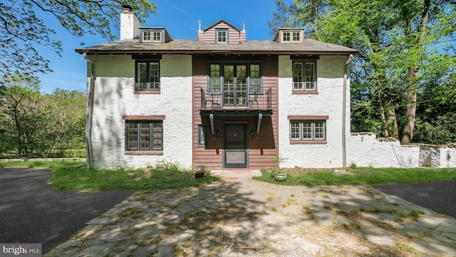 203 E Ferry Rd, Yardley, PA 19067 - view of front of property with a balcony, a chimney, and stucco siding