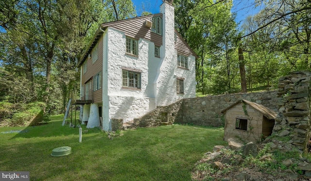 203 E Ferry Rd, Yardley, PA 19067 - view of side of property with stone siding, stucco siding, a chimney, and a lawn