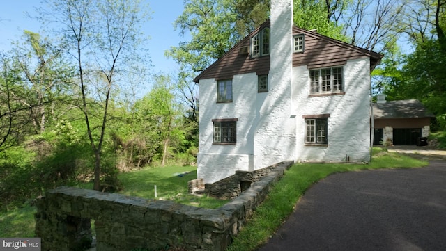 203 E Ferry Rd, Yardley, PA 19067 - view of side of home featuring a yard, stucco siding, and a chimney