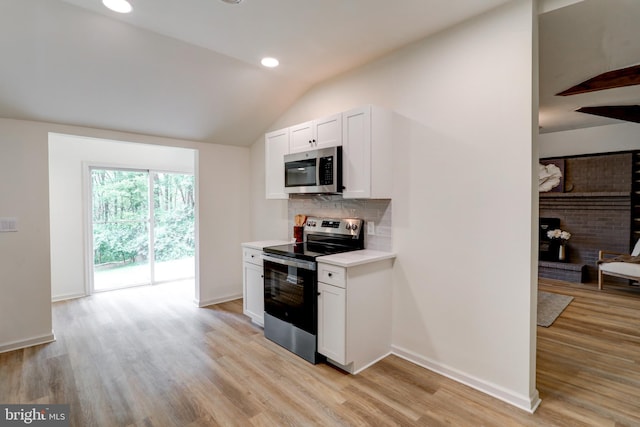 42 Heidi Rd, Delta, PA 17314 - kitchen featuring stainless steel appliances, light countertops, lofted ceiling, tasteful backsplash, and light wood finished floors