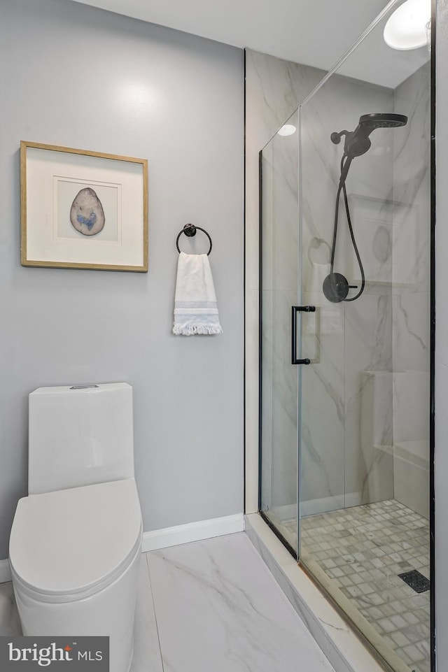 bathroom with a marble finish shower, marble finish floor, baseboards, and toilet