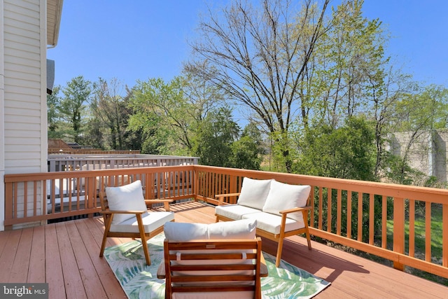 wooden terrace featuring outdoor lounge area