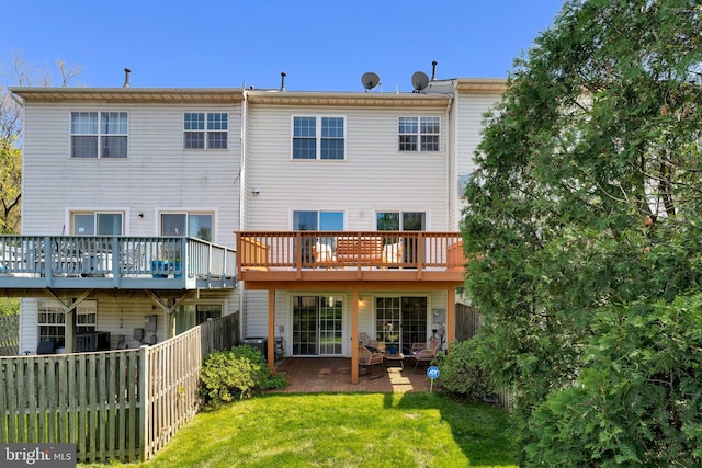 rear view of property with a patio area, fence, and a lawn