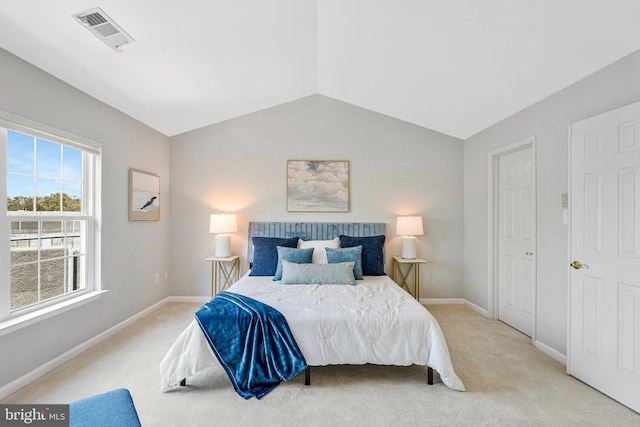 bedroom featuring vaulted ceiling, light colored carpet, baseboards, and visible vents