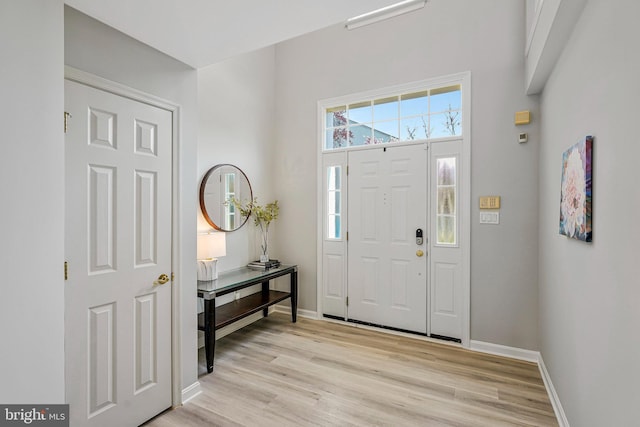 entrance foyer featuring baseboards and light wood-style flooring