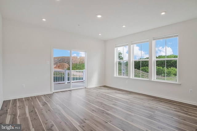 1646 Aster Ln, Hanover, MD 21076 - spare room featuring wood finished floors, healthy amount of natural light, baseboards, and recessed lighting
