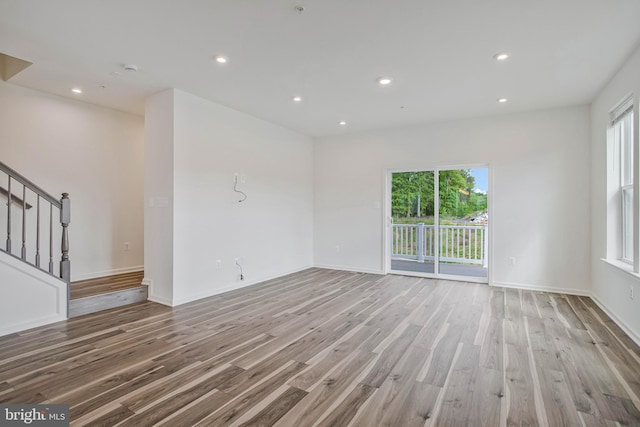 1646 Aster Ln, Hanover, MD 21076 - unfurnished living room with plenty of natural light, wood finished floors, stairs, recessed lighting, and baseboards