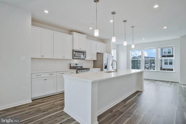 1646 Aster Ln, Hanover, MD 21076 - kitchen featuring appliances with stainless steel finishes, a sink, a center island with sink, dark wood-type flooring, and white cabinetry
