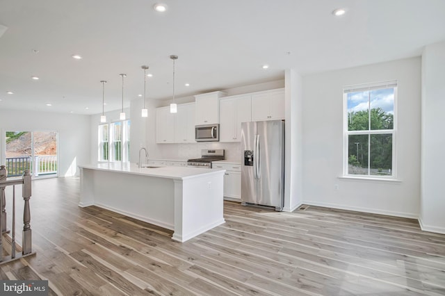 1646 Aster Ln, Hanover, MD 21076 - kitchen featuring appliances with stainless steel finishes, a sink, light wood finished floors, light countertops, and white cabinets
