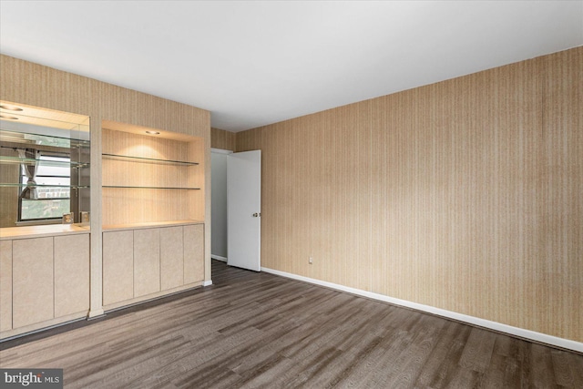 6317 Park Heights Ave Unit 616, Baltimore, MD 21215 - unfurnished room with baseboards, wallpapered walls, and dark wood-style floors