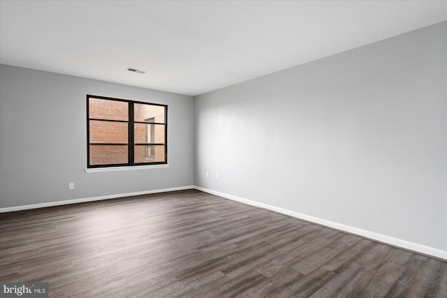 6317 Park Heights Ave Unit 616, Baltimore, MD 21215 - spare room featuring dark wood-type flooring, baseboards, and visible vents