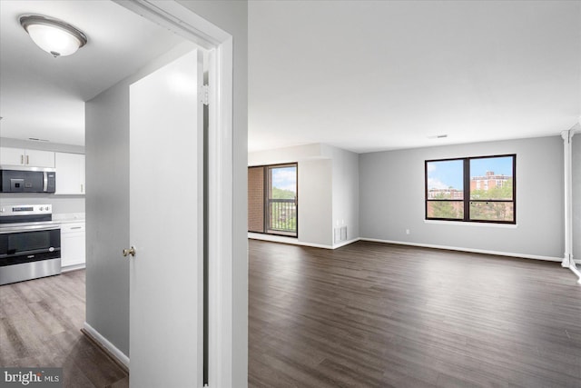 6317 Park Heights Ave Unit 616, Baltimore, MD 21215 - hall featuring a wealth of natural light, baseboards, and dark wood-style floors