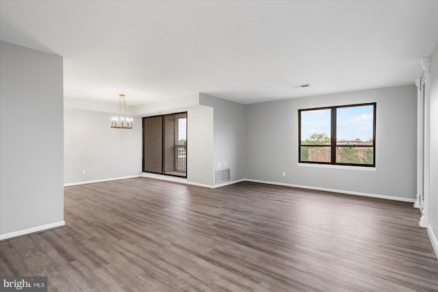 6317 Park Heights Ave Unit 616, Baltimore, MD 21215 - unfurnished living room featuring a chandelier, visible vents, dark wood-style flooring, and baseboards