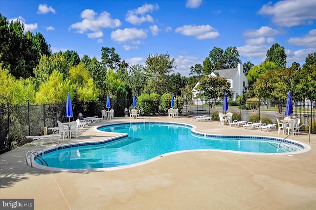 10288 Broken Sound Blvd, Ocean City, MD 21842 - community pool with a patio, fence, and view of wooded area