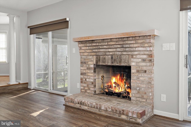 10288 Broken Sound Blvd, Ocean City, MD 21842 - detailed view of wood finished floors, a fireplace, baseboards, and ornate columns