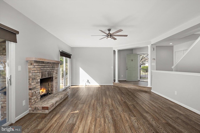 10288 Broken Sound Blvd, Ocean City, MD 21842 - unfurnished living room with a brick fireplace, ceiling fan, baseboards, and wood finished floors
