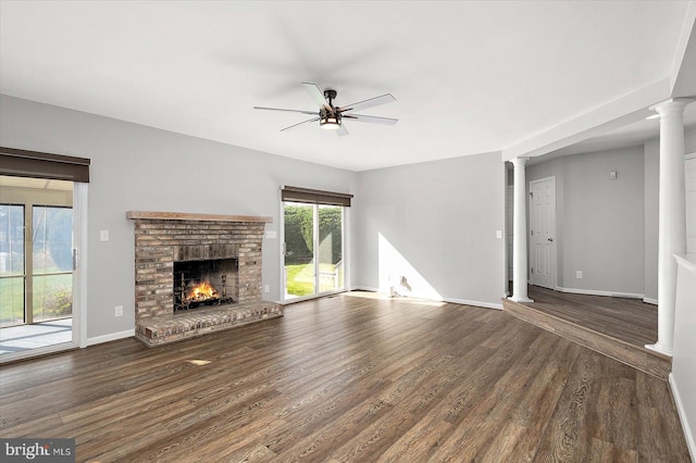 10288 Broken Sound Blvd, Ocean City, MD 21842 - unfurnished living room with ornate columns, a ceiling fan, wood finished floors, and a brick fireplace