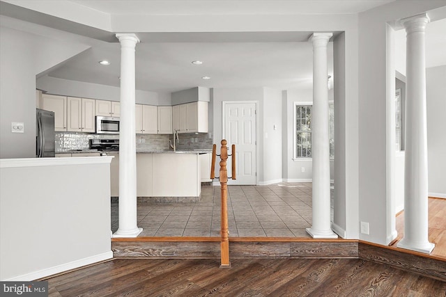 10288 Broken Sound Blvd, Ocean City, MD 21842 - kitchen featuring stainless steel appliances, tasteful backsplash, white cabinets, wood finished floors, and recessed lighting
