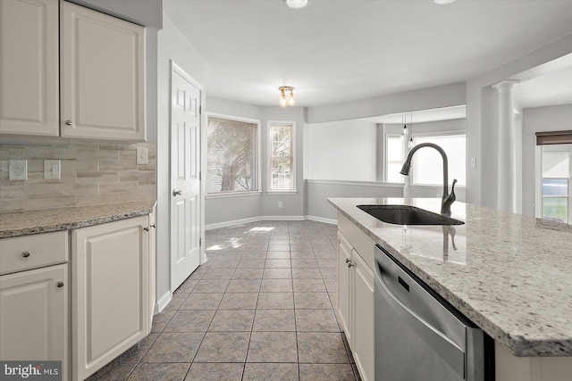10288 Broken Sound Blvd, Ocean City, MD 21842 - kitchen featuring stainless steel dishwasher, a sink, baseboards, and plenty of natural light