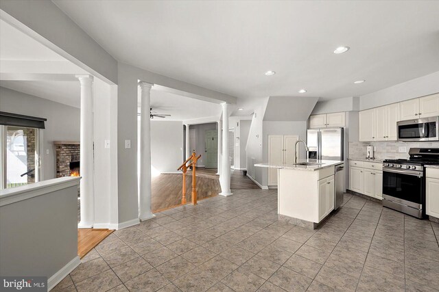 10288 Broken Sound Blvd, Ocean City, MD 21842 - kitchen featuring stainless steel appliances, ornate columns, baseboards, tasteful backsplash, and recessed lighting