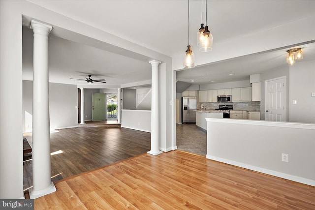 10288 Broken Sound Blvd, Ocean City, MD 21842 - unfurnished living room featuring ornate columns, a ceiling fan, light wood-type flooring, and baseboards