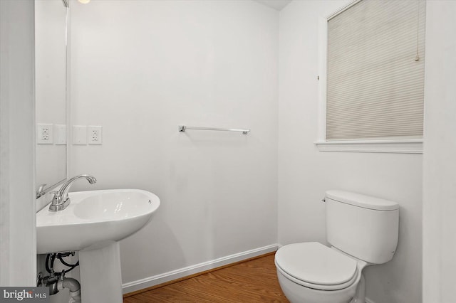 10288 Broken Sound Blvd, Ocean City, MD 21842 - half bathroom featuring baseboards, toilet, wood finished floors, and a sink