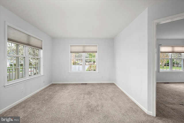 10288 Broken Sound Blvd, Ocean City, MD 21842 - carpeted empty room with plenty of natural light and baseboards