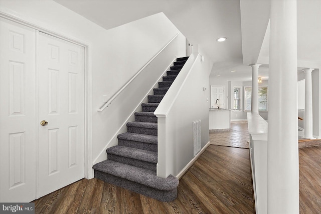 10288 Broken Sound Blvd, Ocean City, MD 21842 - staircase featuring ornate columns, wood finished floors, recessed lighting, and baseboards