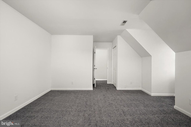 10288 Broken Sound Blvd, Ocean City, MD 21842 - additional living space with dark colored carpet, baseboards, and lofted ceiling
