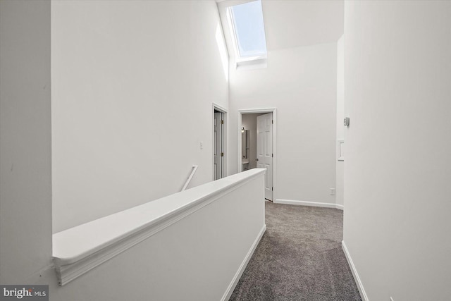 10288 Broken Sound Blvd, Ocean City, MD 21842 - hall with carpet, baseboards, a towering ceiling, and an upstairs landing