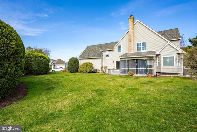 10288 Broken Sound Blvd, Ocean City, MD 21842 - back of house with a sunroom, a chimney, a yard, and a shingled roof