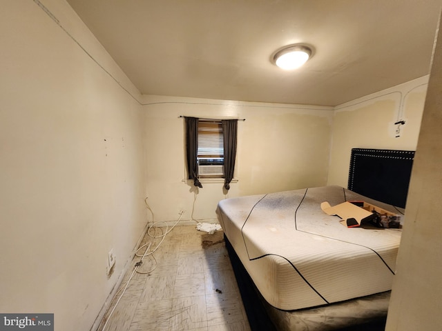 bedroom featuring cooling unit and baseboards