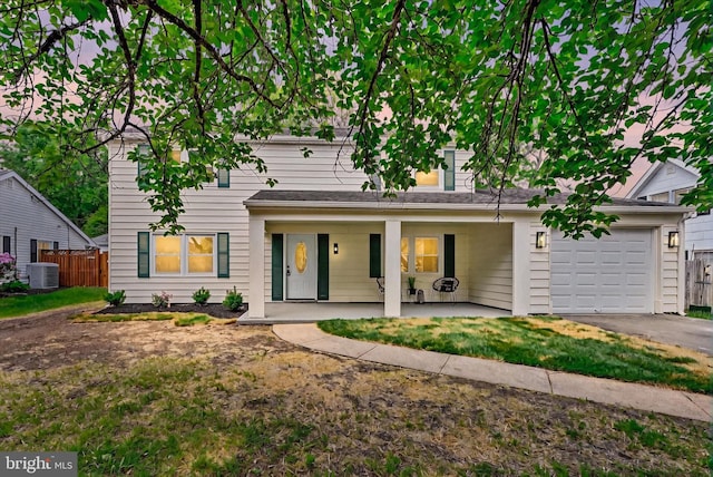 view of front of home featuring an attached garage, cooling unit, asphalt driveway, fence, and covered porch