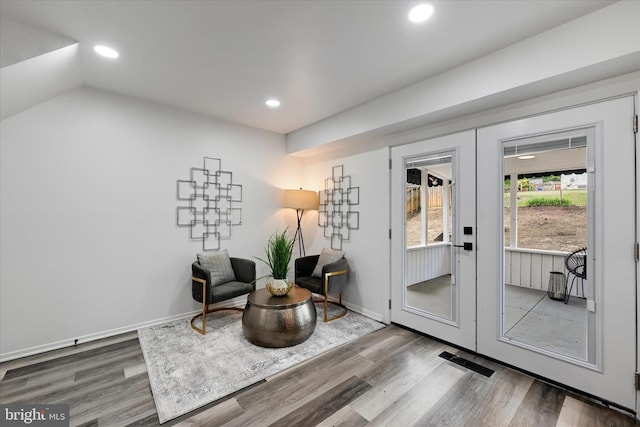 living area with french doors, wood finished floors, recessed lighting, baseboards, and lofted ceiling