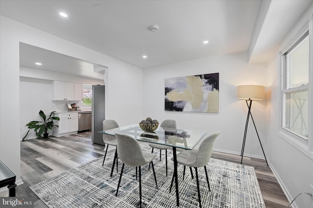 dining space with light wood finished floors, recessed lighting, and baseboards