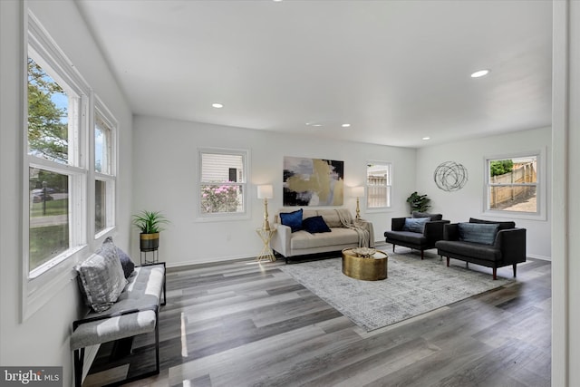 living area with wood finished floors, recessed lighting, and baseboards