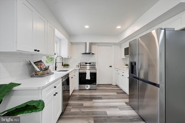 kitchen with appliances with stainless steel finishes, a sink, white cabinets, light countertops, and recessed lighting