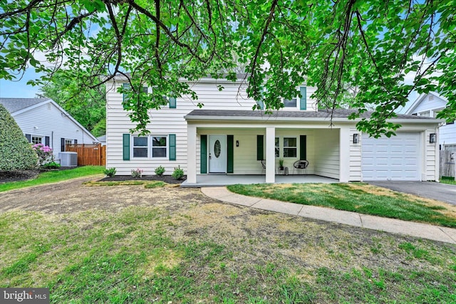 view of front of property featuring a garage, central air condition unit, a porch, and asphalt driveway