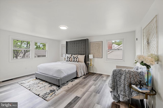 bedroom with wood finished floors and baseboards