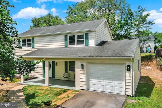 view of front of property with an attached garage, driveway, and a shingled roof