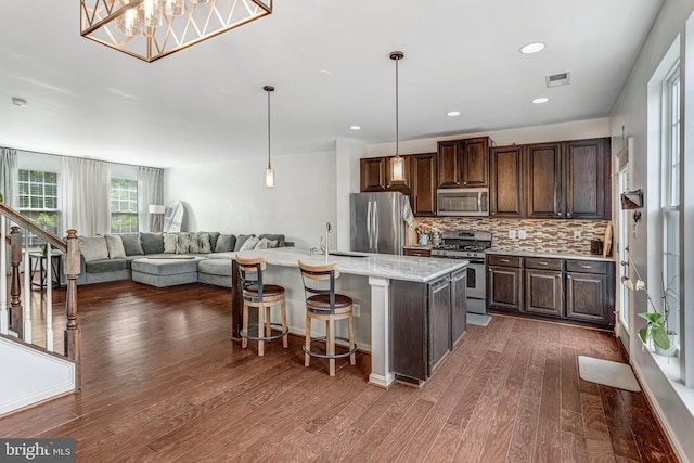 11972 Tygart Lake Dr, Bristow, VA 20136 - kitchen featuring appliances with stainless steel finishes, dark brown cabinets, dark wood-style flooring, backsplash, and recessed lighting