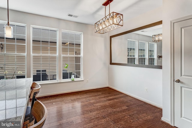 11972 Tygart Lake Dr, Bristow, VA 20136 - unfurnished dining area with a chandelier and wood finished floors