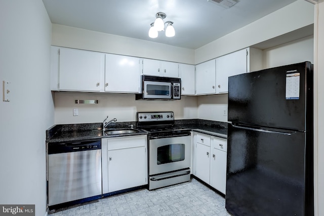 275 Green St Unit 4G1, Edgewater Park, NJ 08010 - kitchen with freestanding refrigerator, electric range, dishwashing machine, dark countertops, and white cabinetry
